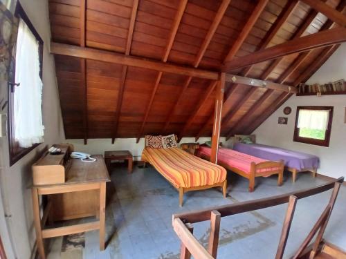Habitación en el ático con 2 camas y mesa en Alquilo casa en Villa Gesell por temporada, en Villa Gesell