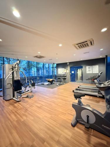 a gym with treadmills and exercise equipment in a building at Dorsett Residences Executive KL in Kuala Lumpur