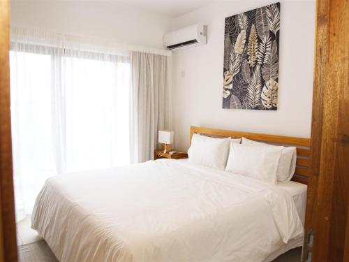 Ένα ή περισσότερα κρεβάτια σε δωμάτιο στο Golden Square Homes - Flic en Flac