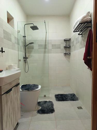 a bathroom with a shower and a toilet and a sink at Dar naima in Al Ghar