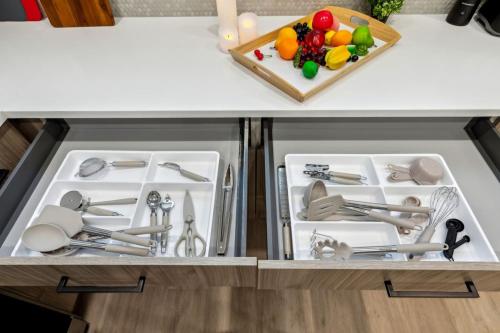 a kitchen counter with two white trays with utensils at The Euclase 2BD TownHouse in the heart of FortWorth in Fort Worth