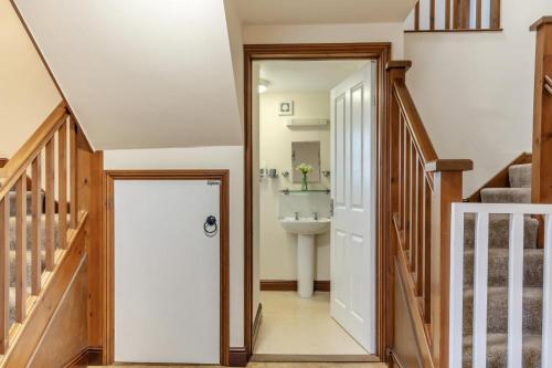 a hallway with a bathroom with a sink and a staircase at 2 Bed in Whitwell oc-r33497 in Whitwell