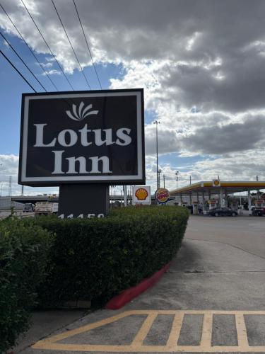 a sign for a lotus inn in a parking lot at Lotus Inn in Houston
