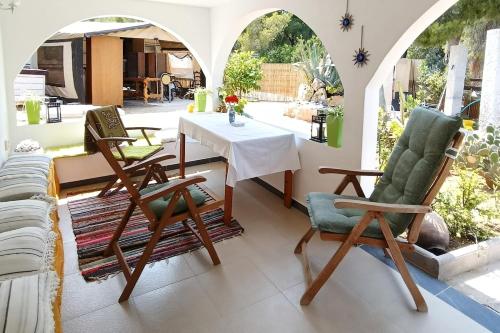 a living room with a table and two chairs at Irini Garden House in Vathí