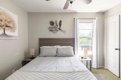 a bedroom with a bed and a ceiling fan at Whitesboros Hidden Gem Cozy Downtown Haven in Whitesboro