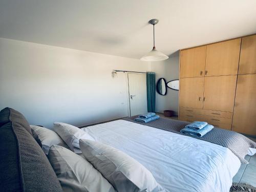 a bedroom with a large bed and a couch at Garden Villa Near Chania s Coastline in Xirostérnion