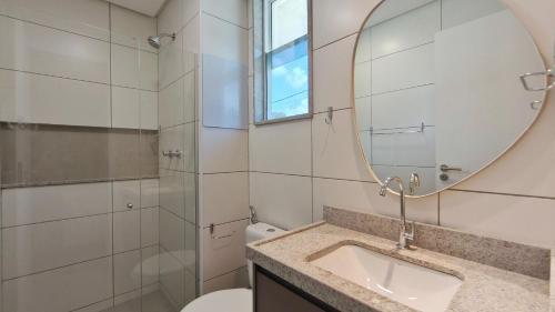 a bathroom with a sink and a mirror at Mila Rooftop - Praia de Tamandaré in Tamandaré