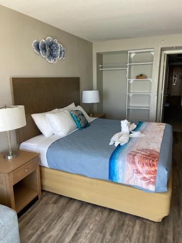 a bedroom with a bed with a stuffed animal on it at Ocean Front King Suit Myrtle Beach Heated Pools Landmark in Myrtle Beach