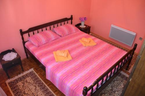 a bedroom with a bed with two wooden boxes on it at Apartment Dragovic in Ulcinj