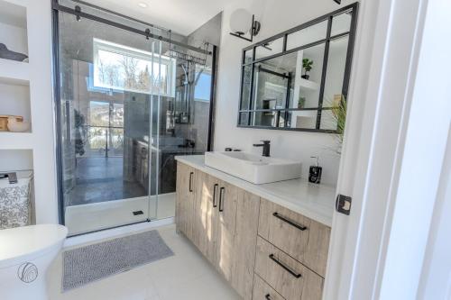 a bathroom with a sink and a glass shower at Le Panorama spa lake access in Saint Come