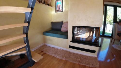 a living room with a fireplace in a tiny house at Red Brick 