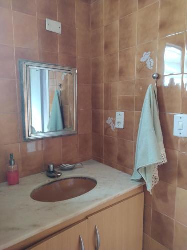 a bathroom with a sink and a mirror at Sebastião Arruda Júnior Recife Boa Vista in Recife