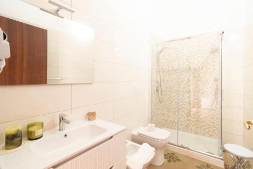 a bathroom with a toilet and a sink and a shower at B&B Gaudio in San Marco Argentano