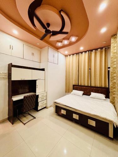 a bedroom with a bed and a ceiling fan at Nest & Fest in Indore