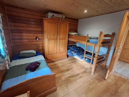 a room with two beds and a bunk bed at Gites des Abbayes in Le Mesnil-sous-Jumièges