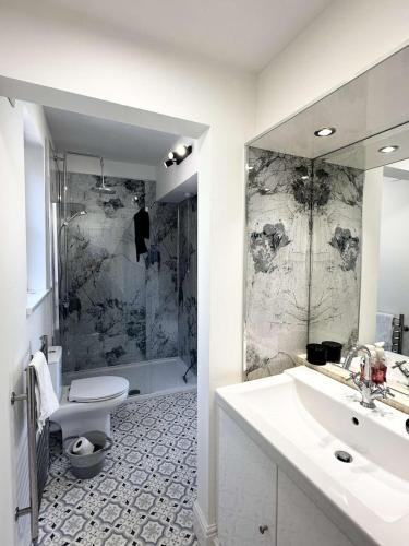 a bathroom with a sink and a toilet and a shower at Lavender Cottage, Welton in Welton