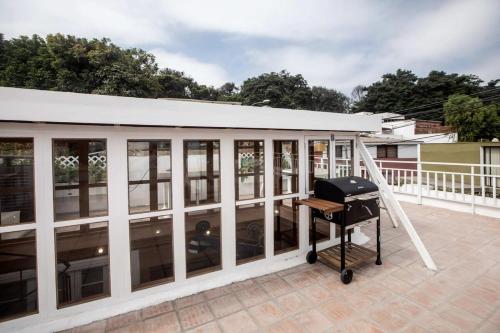 a screened porch with a grill on a roof at Villa with Rooftop Terrace in Barranco in Lima