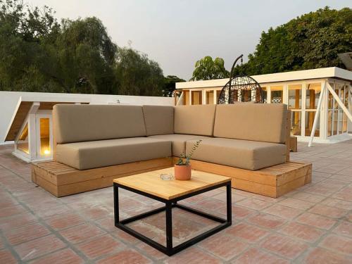 a couch and a coffee table on a patio at Villa with Rooftop Terrace in Barranco in Lima