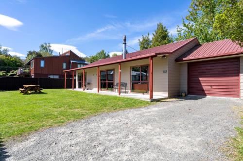 a home with a red roof and a garage at Cozy, Private Central Location in Hanmer Springs