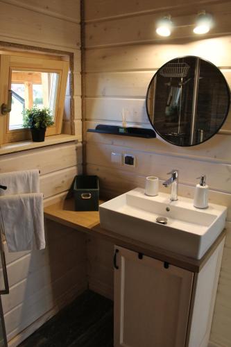 a bathroom with a sink and a mirror at Dom Między Wzgórzami in Tylicz