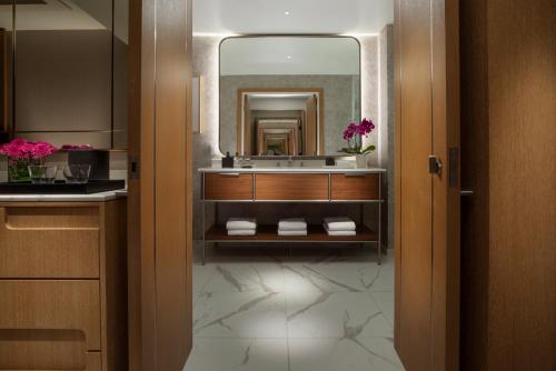 a bathroom with a sink and a mirror at Hilton Arcadia Los Angeles in Arcadia