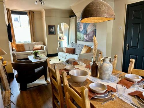 a living room with a wooden table with a dining room at NEW! Stylish Chester Townhouse, Sleeps 6 in Chester