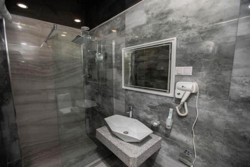 a bathroom with a shower and a toilet and a sink at VIAGGIO Yerevan in Yerevan