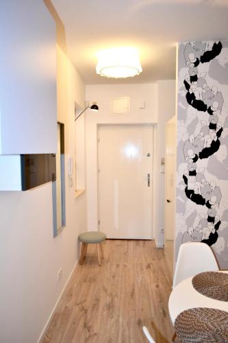 a room with a hallway with a door and a chair at Studio Praga in Warsaw