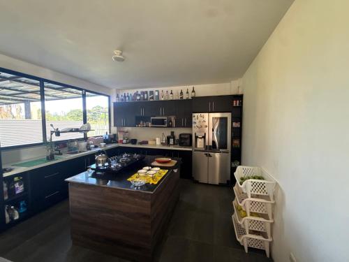 a kitchen with a island in the middle of a room at Villa Mariaclaudia completa in Macas
