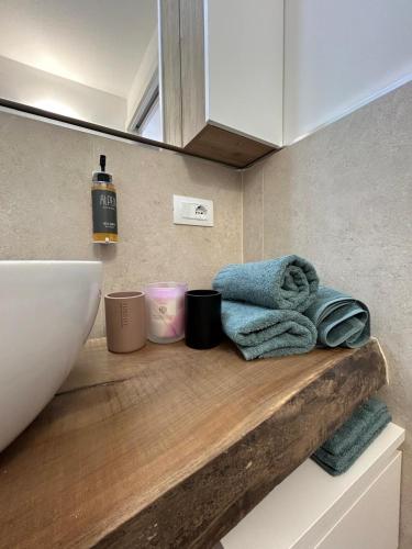 a bathroom with a sink and towels on a counter at Appartamenti reali- La reggia in Venaria Reale