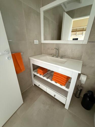 a bathroom with a white sink and a mirror at La Caballeriza in Mercedes