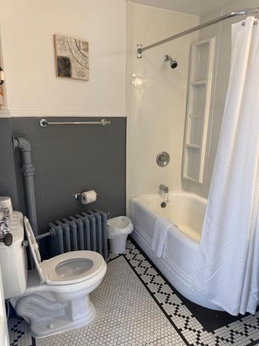 a bathroom with a toilet and a tub and a sink at Midstream Manor Unit 8 - 2 Bedroom Apartment in St. John's