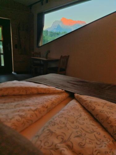 two beds in a room with a projection screen at Wellness Apartment mit Sauna, Outdoor Whirlpool & Kamin in Bischofswiesen