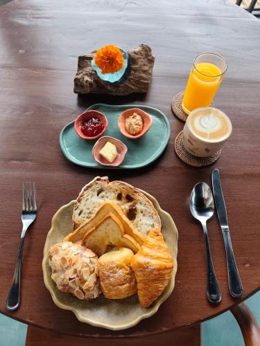 een tafel met een bord brood, eieren en sap bij Living Ubud in Ubud
