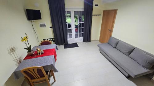a living room with a couch and a table at Apartment Kompara in Ajdovščina
