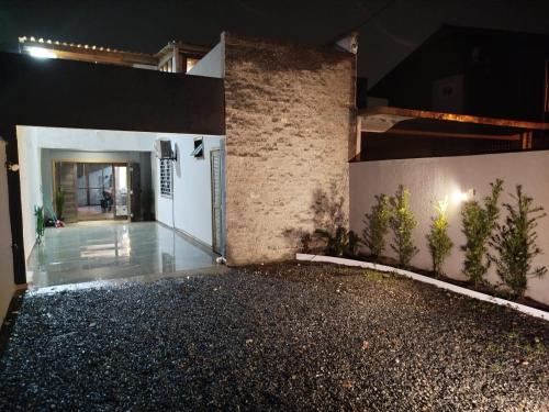 a room with a hallway with plants on the wall at Sobrado São Chico, Ubatuba SFS in São Francisco do Sul