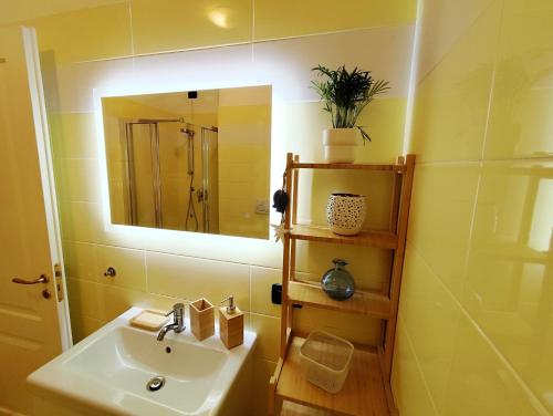 a bathroom with a sink and a mirror at Almarea Beach - Essenza del mare, calore di casa in Imperia
