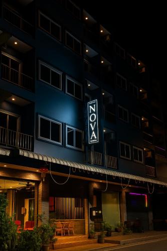 a building with a sign on the side of it at Nova Patong in Patong Beach