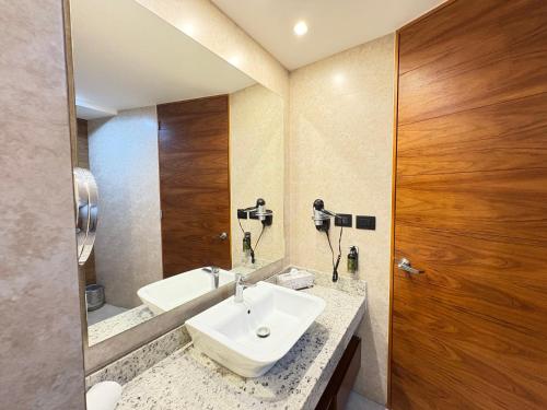 ein Badezimmer mit Waschbecken und Spiegel in der Unterkunft Alojamiento Céntrico En Sonata Lomas Angelopolis in Lomas de Angelopolis