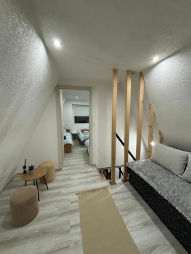 a living room with a bed and a couch in a room at Planinska vila KTM Lisine in Despotovac
