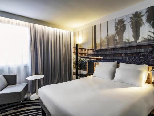 Ένα ή περισσότερα κρεβάτια σε δωμάτιο στο Novotel Saint-Étienne Centre Gare Châteaucreux