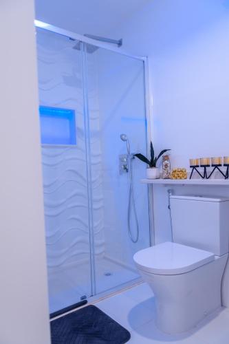 a bathroom with a shower and a toilet at Yes Rooftop, Private Pool & Sea View, Cidadela in Praia