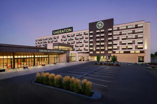 a large building with a sign on top of it at Sheraton Laval Hotel in Laval