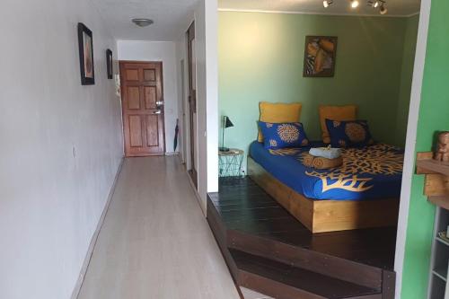 a living room with a blue couch in a room at LA PERLE VERTE - Spacious studio near Papeete waterfront in Te Auae