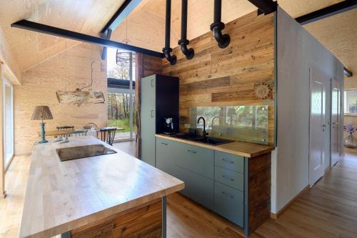 a kitchen with a sink and a counter top at 4 Strony Lasu in Gołaczów