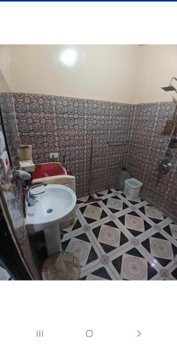a bathroom with a toilet and a sink in it at Downtown Apartment in Aswan