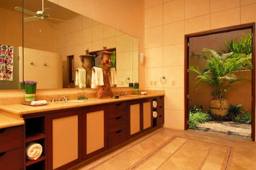 a bathroom with a sink and a large mirror at Luxury Villa Paloma Blanca in Cruz de Huanacaxtle