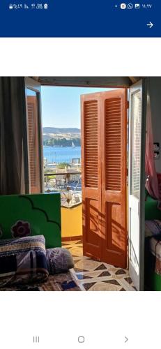 a room with a window with a view of the ocean at Downtown Apartment in Aswan