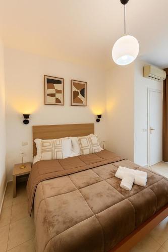 a bedroom with a large bed with two pillows at Hotel Aurelia Milano Centrale in Milan