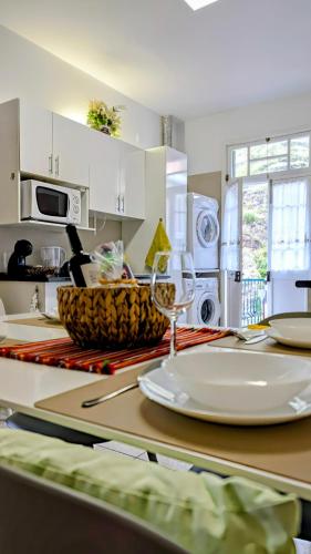 a kitchen with a table with a plate on it at Banana Lovers - Farm View in Ribeira Brava